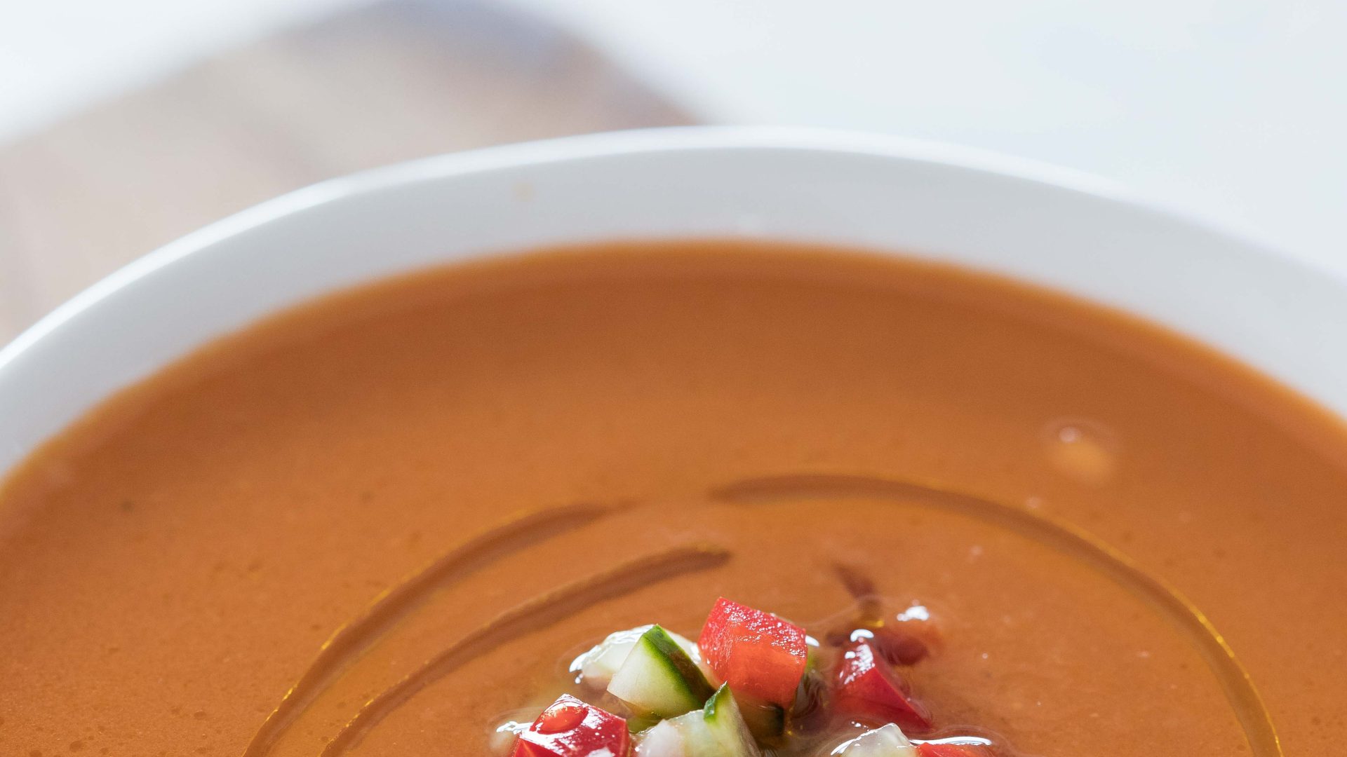 Bol de gazpacho frais Santa Teresa, garni de légumes croquants.