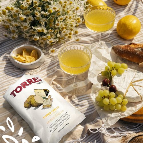 Chips Patatas Torres goût queso curado avec verres de sangria blanche et fruits d’été.