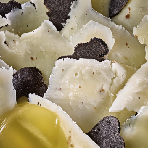 Fromage Manchego affiné avec éclats de truffe noire et huile d’olive.